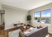 Thumbnail 16 of 27 - a living room with a large window and a couch
